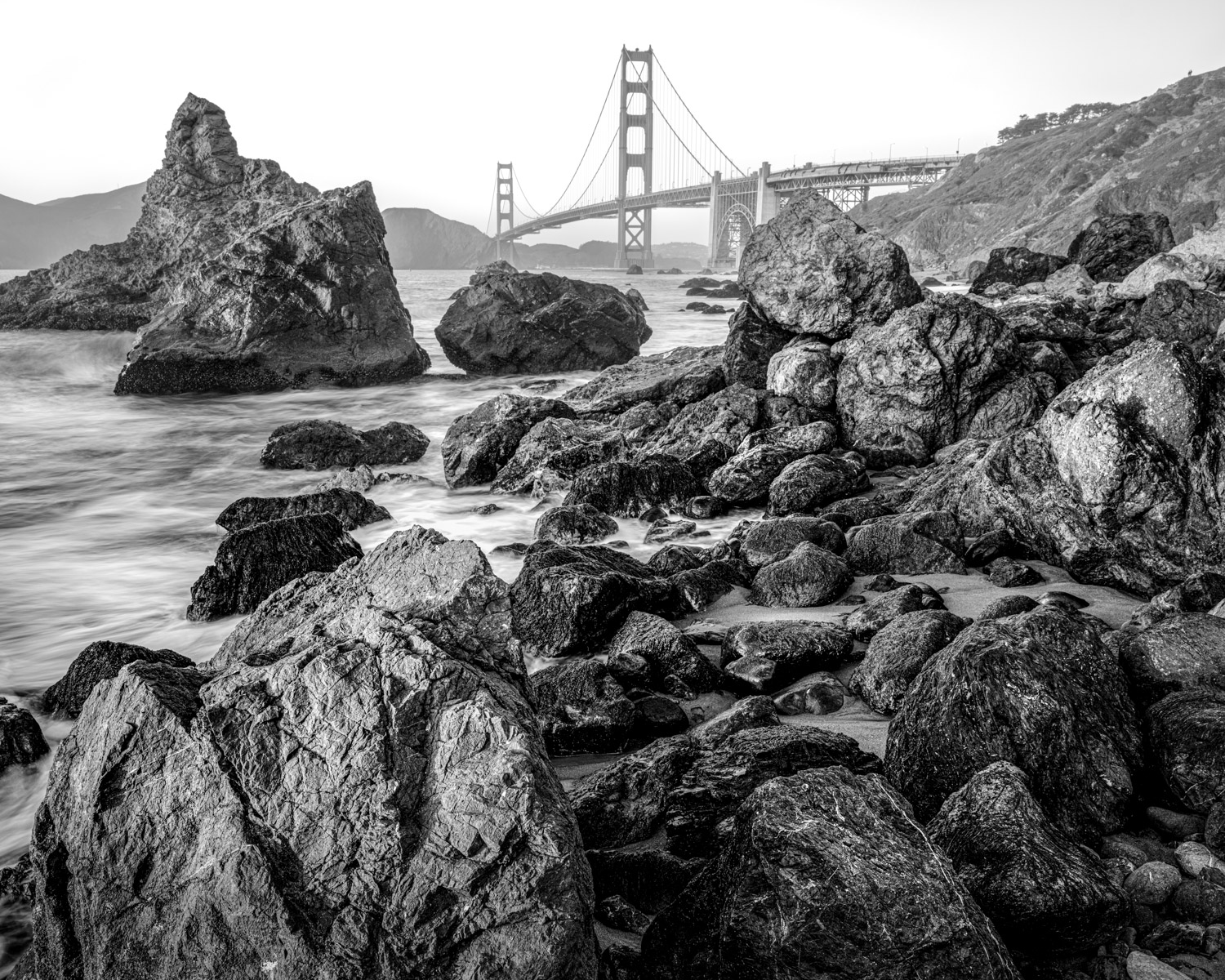 rocky shore line with the ocean and Golden Gate Bridge